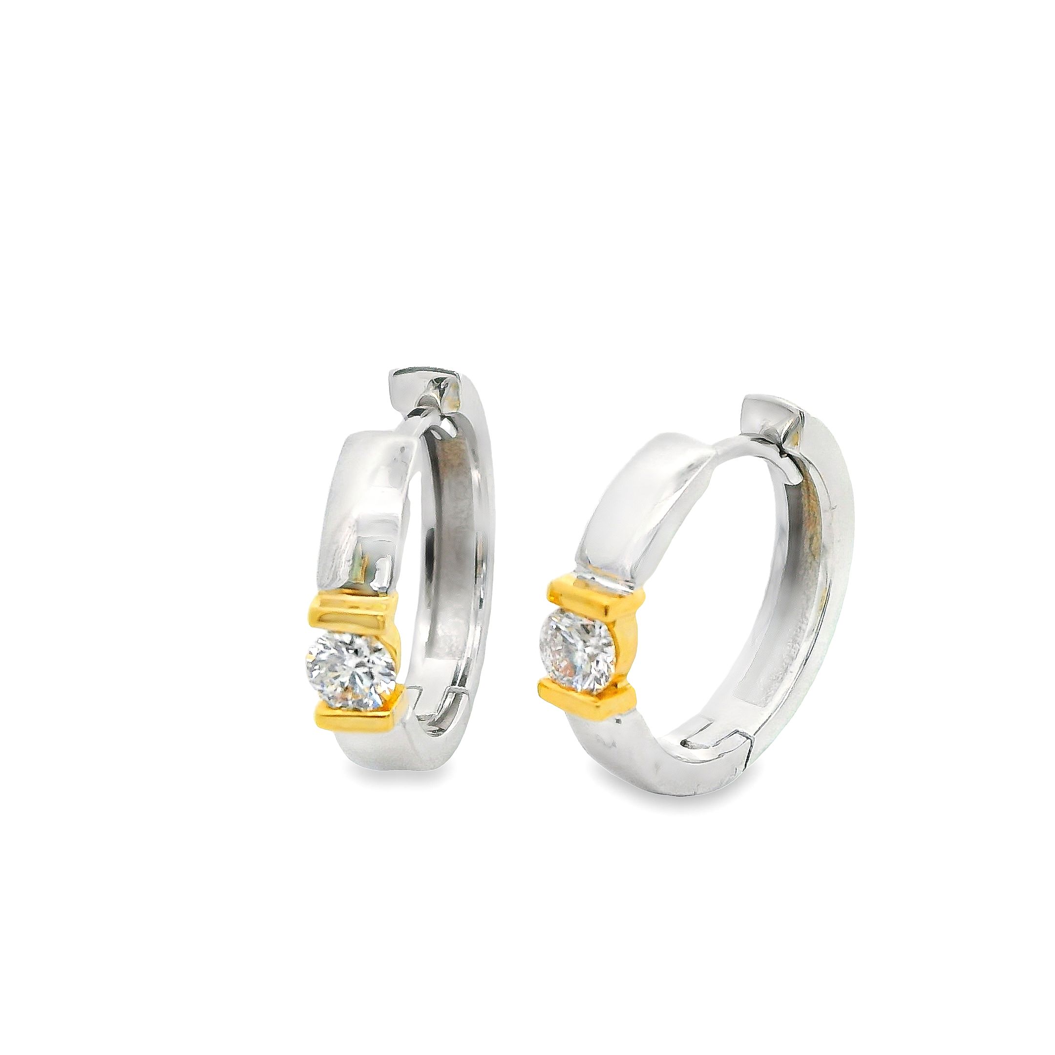 Deze oorringen van Louis Bros zijn vervaardigd uit 18 karaat bicolor (6. gr.) en zijn gezet met 2 briljant geslepen diamanten met een totaalgewicht van 0.34ct. De Oorsieraden hebben een diameter van 15 mm en een breedte van 3 mm.
 Deze oorringen zijn vervaardigd uit twee soorten goud, vaak wit- en geelgoud, wat een prachtig contrast en een unieke uitstraling geeft. In het midden van elke oorring schittert een verfijnd diamantje, dat een vleugje luxe en sprankeling toevoegt. Deze tijdloze sieraden zijn perfect voor elke gelegenheid, van dagelijkse elegantie tot speciale evenementen, en zijn een must-have in elke sieradencollectie.
