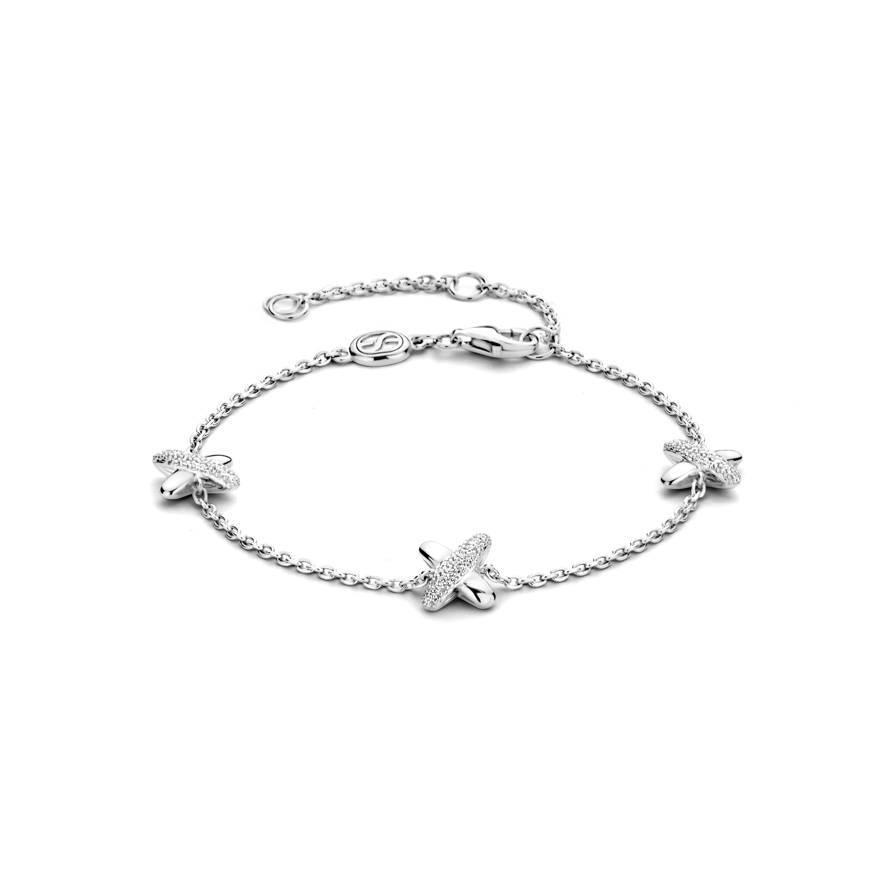 Ontdek pure tijdloze verfijning met deze TI SENTO zilveren charm armband 23048ZI. Gemaakt van 925 sterling zilver en bedekt met platina voor een langdurige schittering, beschikt deze armband over een betoverende reeks kruisjes. Elk charm is versierd met een fonkelende pave van witte cubic zirconia-stenen, wat een schitterend effect creëert. Deze armband is een perfecte fusie van traditie en eigentijds design, en biedt een veelzijdig accessoire dat elke outfit aanvult. Het kruisje, een tijdloos symbool van oneindigheid en hoop, voegt een vleugje mystieke elegantie toe. Verrijk je dagelijkse look met dit prachtige stuk. Draag het alleen voor een minimalistische statement of combineer het met andere TI SENTO armbanden voor een persoonlijke touch. Met zorg vervaardigd voor gevoelige huid, garandeert deze nikkelvrije en hypoallergene armband blijvend comfort en kwaliteit.

De armband heeft een standaardlengte van 16 cm en heeft een verlengstuk van 4 cm. Hierdoor kan je de armband op 3 verschillende lengtematen dragen, op 16 cm, 18 cm en 20 cm.