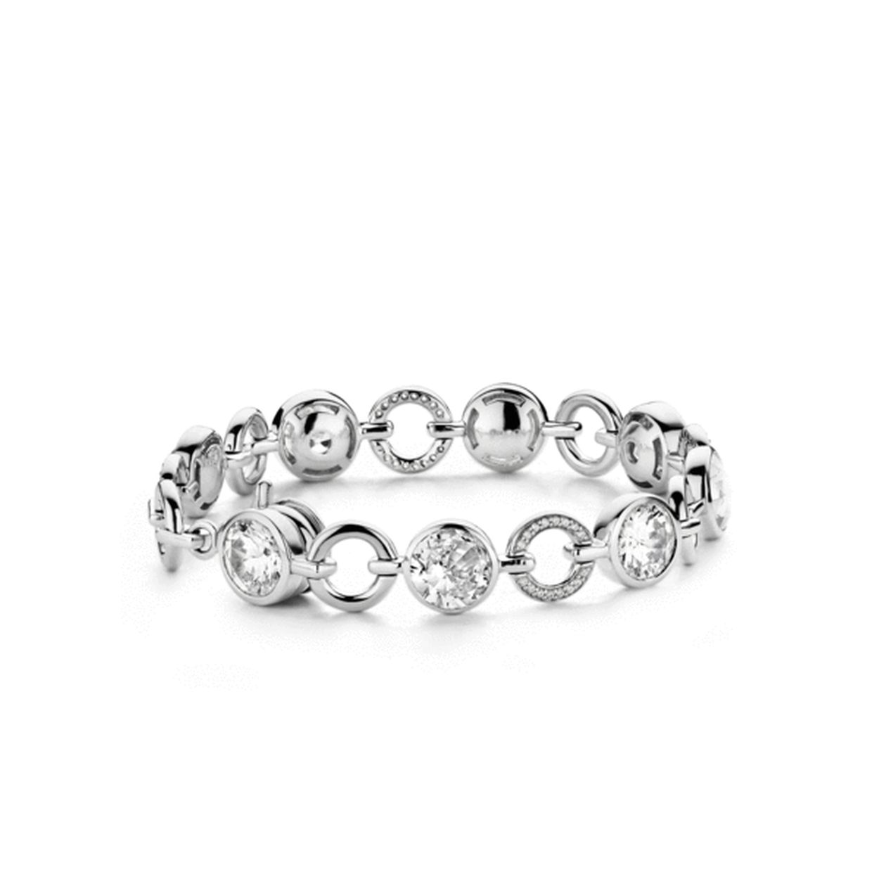 TI SENTO biedt met haar sieraden altijd iets extra's. Zo is het mooiste detail van deze TI SENTO - Milano armband tevens het best weggewerkt in het ontwerp: het slotje. De armband heeft hierdoor geen voor- of achterzijde. Het rondom draagbare ontwerp heeft afwisselend briljant geslepen witte zirkonia's in een bezel zetting pavé gezette zirkonia's in cirkels en gladgepolijste cirkels. De armband is gemaakt van gerhodineerd sterling zilver. De rhodiumlaag over het zilver zorgt voor extra glans en een langere levensduur van het sieraad.