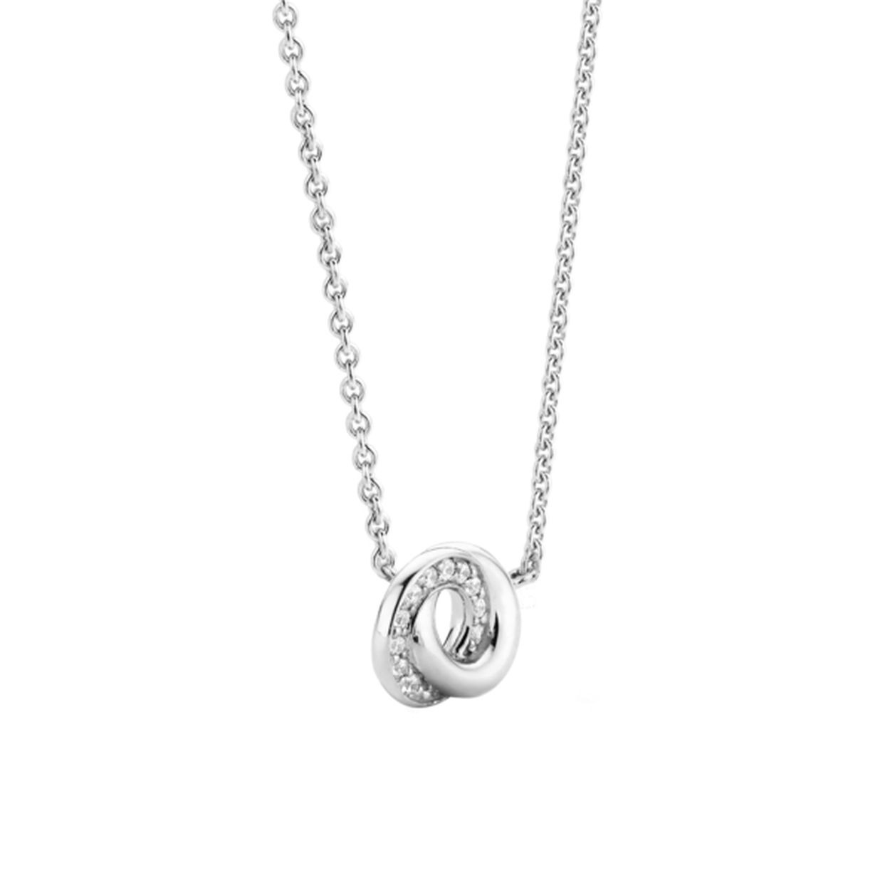 De egale zilveren band en witte zirkonia pavé zetting zijn oneindig met elkaar verbonden. Met een glinstering dansen ze op deze delicate zilveren ketting. Een zilveren schoonheid.