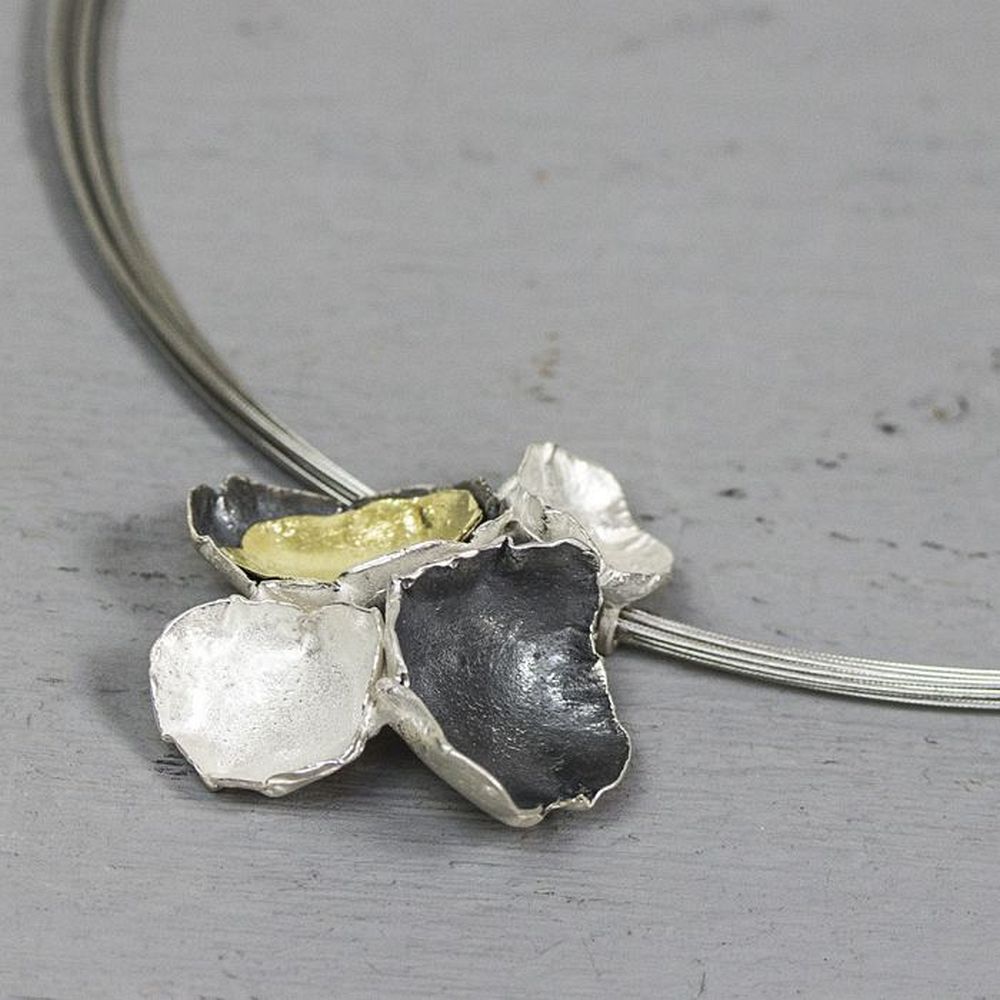 Hanger gemaakt van 925 sterling zilver, geoxideerd zilver en zilver verguld. Deze hanger bestaat uit verschillende organische elementen die samen een bloem vormen. Combineer met een spang, een paar mooie oorbellen, een ring en een armband voor een complete look!