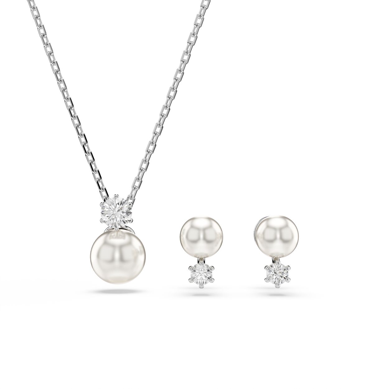 Deze prachtige, iconische Matrix-set bestaat uit een schitterende hanger en oorbellen. De hanger wordt gedragen aan een elegante ketting met rhodium toplaag en is voorzien van een witte Swarovski Crystal Pearl en een Swarovski Zirkonia in Round-slijpvorm. Dezelfde prachtige combinatie wordt gespiegeld in de oorknoppen. Draag ze met een T-shirt en spijkerbroek voor een relaxte maar in het oog springende look.
