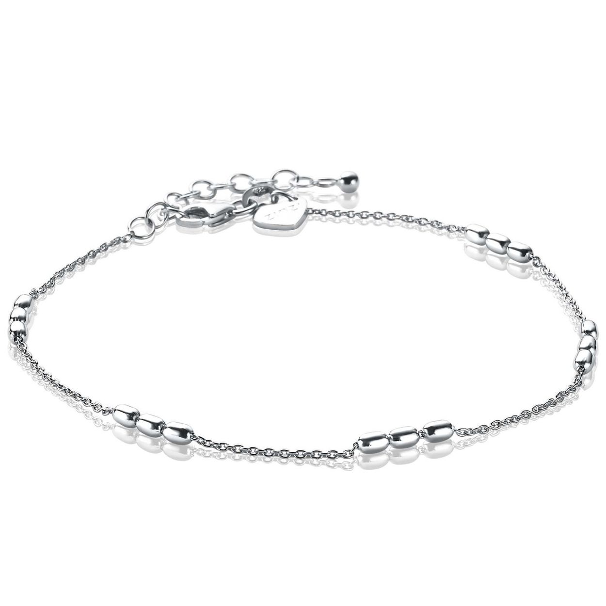 ZINZI zilveren fantasie enkelband, bestaande uit een anker schakelketting met drie ovale staafjes. Deze ovaaltjes zijn gelijk verdeeld over de enkelband. De lengte van de enkelband is 23cm én voorzien van een extra verlengkettinkje van 4cm, waardoor iedere enkel (smal of breed) deze 'glimmers' kan dragen. Met herkenbaar Zinzi hartje bij de sluiting. De enkelband is vervaardigd van eerste gehalte zilver (925) en voorzien van een extra rodiumlaag voor een langdurige glans.