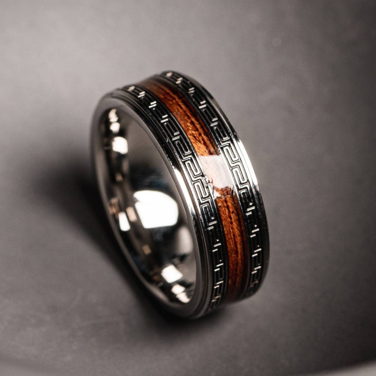 Even when it doesn’t seem like it at first glance, numbers play an incredibly important role. Without mathematics, we’d spend most of our lives without any clear direction.

Discover our “Numerary” ring made from stainless steel in silver and with a core composed of Hawaiian koa wood. The special coating on the wood means this piece of nature is guaranteed waterproof, and the mysterious engravings awaken associations of times gone by and fantastic creatures. Bring a bit of fantasy into your otherwise measured daily life.