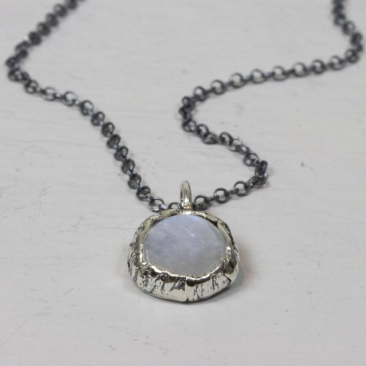 Collier gemaakt van 925 geoxideerd sterling, met aan het collier een hanger van zilver met daarin een Maansteen.