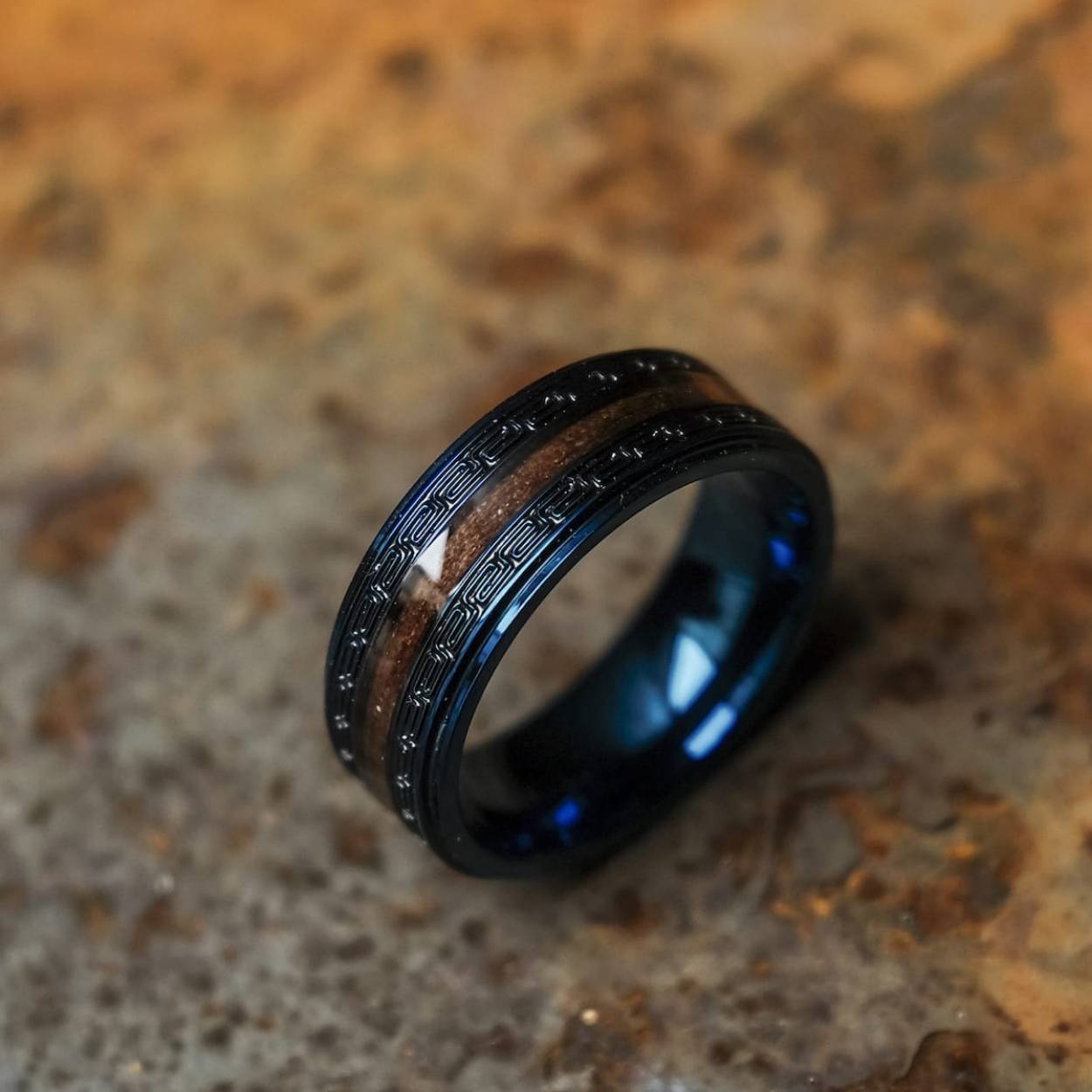 Even if it doesn't seem like it at first glance, numbers play an insanely big role. Without math, we'd just be passing each other by our entire lives.

Discover our "Numerary" ring with a heart of warm walnut wood and stainless steel in blue. The special coating of the wood makes this unique piece guaranteed waterproof, and the intricate engravings suggest associations of times past and fantastic beings. Bring a little fantasy into your strictly paced daily life with this ring!
