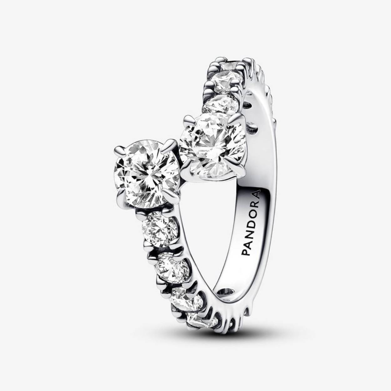 Sprankel in stijl met de sterlingzilveren sprankelende overlappende bandring uit de Pandora Timeless Collection. Deze ring in koele tinten is afgewerkt met een rij zorgvuldig gezette heldere zirkonia. De band overlapt subtiel in het midden, met grotere stenen aan beide uiteinden, en vormt een opvallend middelpunt. Dit sieraad is geïnspireerd op Pandora's sprankelende rij eeuwigheidsringen en heeft een gedurfde, dimensionale look. Til je stijl naar een hoger niveau met deze prachtige sterlingzilveren ring.