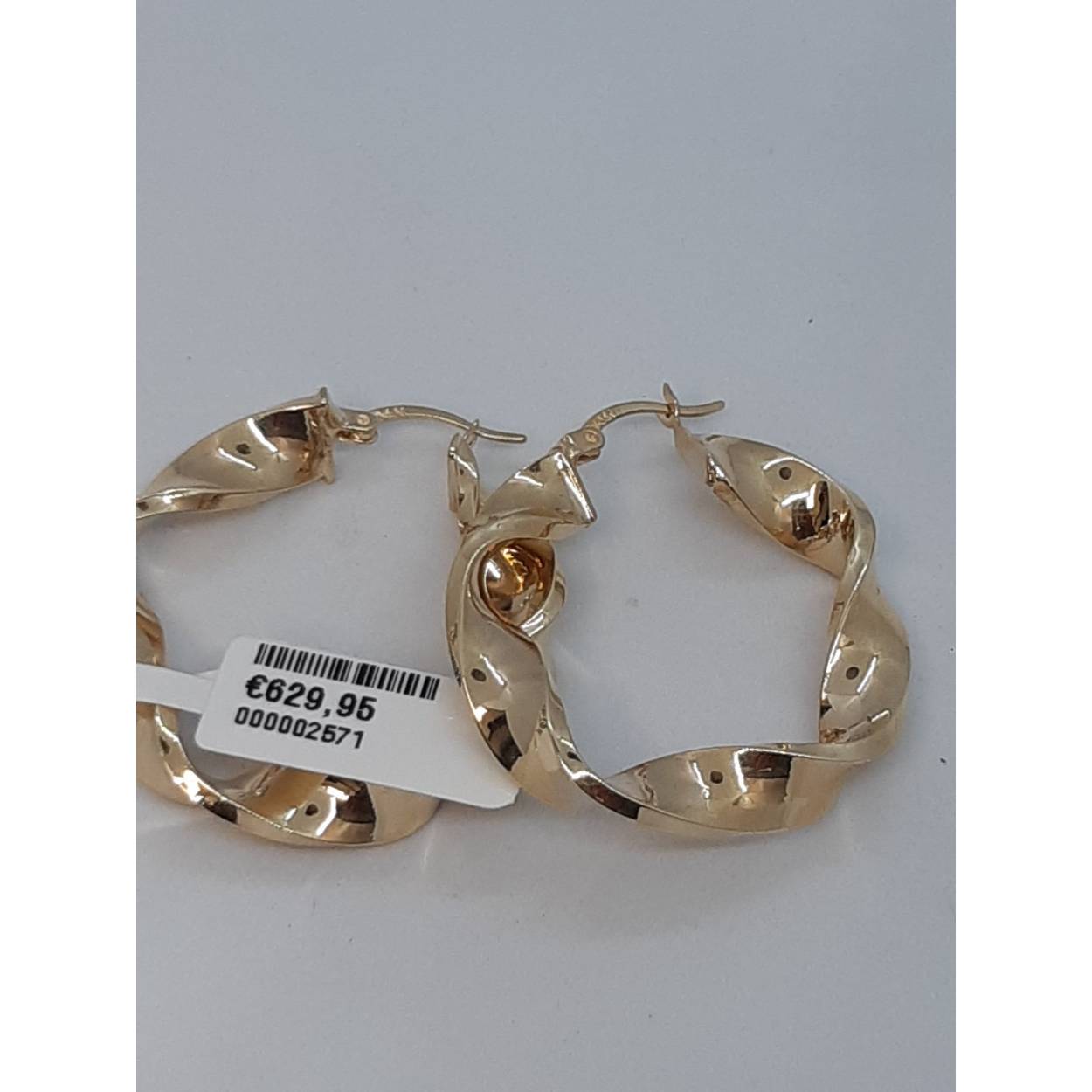 De gouden oorbellen van modelnummer BREA-0002320 zijn creolen gemaakt van 14-karaats goud, met een glanzende afwerking. Ze hebben een breedte van 6 mm en een mooie goudkleur. Perfect voor zowel dagelijks gebruik als speciale gelegenheden. Draag ze met opgestoken haar voor een elegante uitstraling, ideaal voor elke outfit.