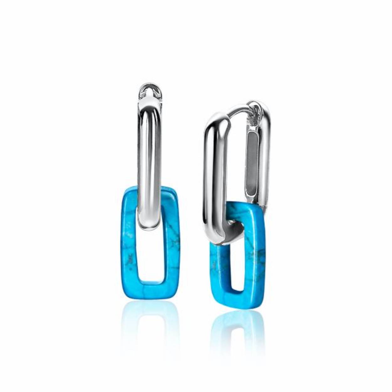 ZINZI zilveren ovale oorringen met open ovalen in turquoise howliet edelsteen. De doorsnede van deze oorringen is 18mm. Met luxe scharniersluiting. Vervaardigd van eerste gehalte zilver (925) en voorzien van extra rodiumlaag voor een witgouden uitstraling.