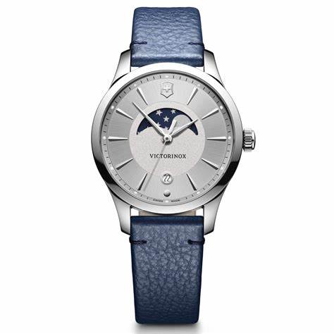 Stainless steel case with a blue leather strap. Fixed stainless steel bezel. Silver dial with silver-tone hands and index hour markers. Minute markers around the outer rim. Dial Type: Analog. Date display above the 6 o'clock position. Moon-phase aperture. Quartz movement. Scratch resistant sapphire crystal. Pull / push crown. Solid case back. Round case shape. Case size: 35 mm. Case thickness: 8. Band width: 17 mm. Tang clasp. Water resistant at 100 meters / 330 feet. Functions: date, hour, minute, second, moon-phase. Dress watch style. Watch label: Swiss Made. Victorinox Alliance Small Silver Dial Ladies Watch 241832.