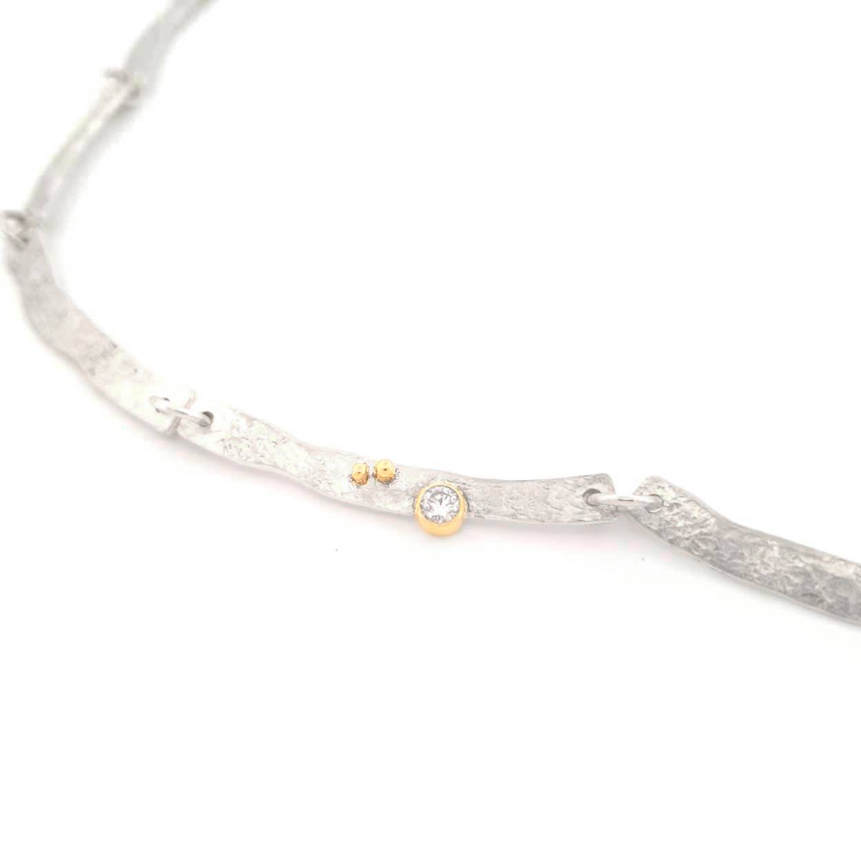 De bewerkte schakels vormen samen de loop van de rivier. 
Met een bijzondere plaatsing van de edelsteen en de gouden details straal je met deze ketting om je hals pure luxe uit. 

Maak een afspraak en kom deze sierlijke ketting eens passen! Of bestel haar gelijk, dan sturen we deze mooi verpakt naar je toe.