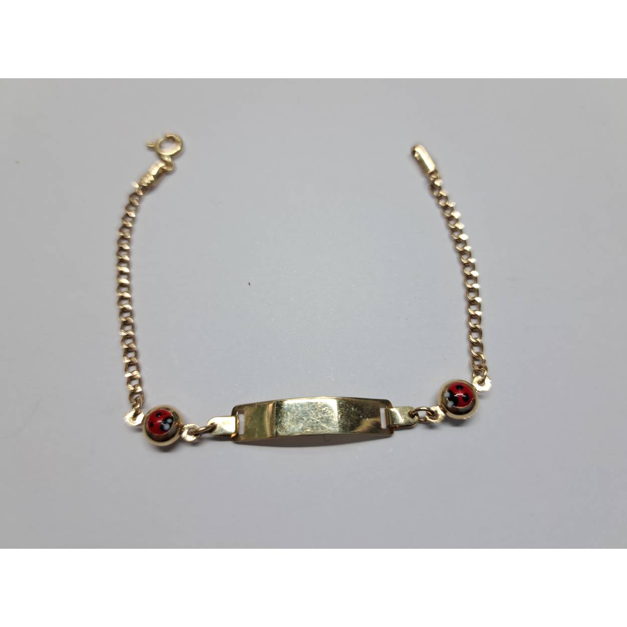 14 Karaat geel gouden baby armband met lieveheersbeestje. 
Gourmet schakel. 