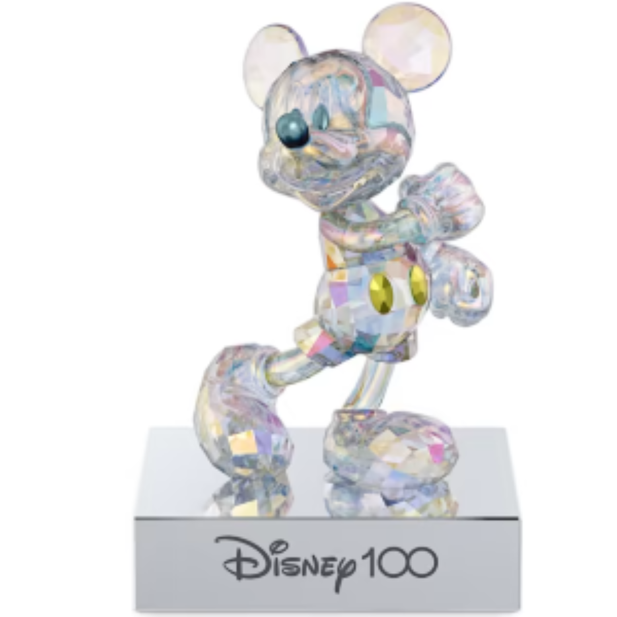 This ultra-radiant Mickey Mouse-inspired figurine celebrates Disney100 with a beautiful example of Swarovski's savoir-faire. Showing Mickey in a typically dynamic pose cut with 530 facets, it has a reflective platinum look created with an all-over coating of our signature Aurora Borealis effect for increased shimmer and intensity. The metallic base has a chrome finish and black velvet bottom, with "Disney100" engraved on the front. The figurine can be removed from the base and placed anywhere in your home. A playful piece that commemorates one of the world’s most beloved animated characters. Decoration object. Not a toy. Not suitable for children under 15. This Disney product is sold as a special Annual Edition for 2023.