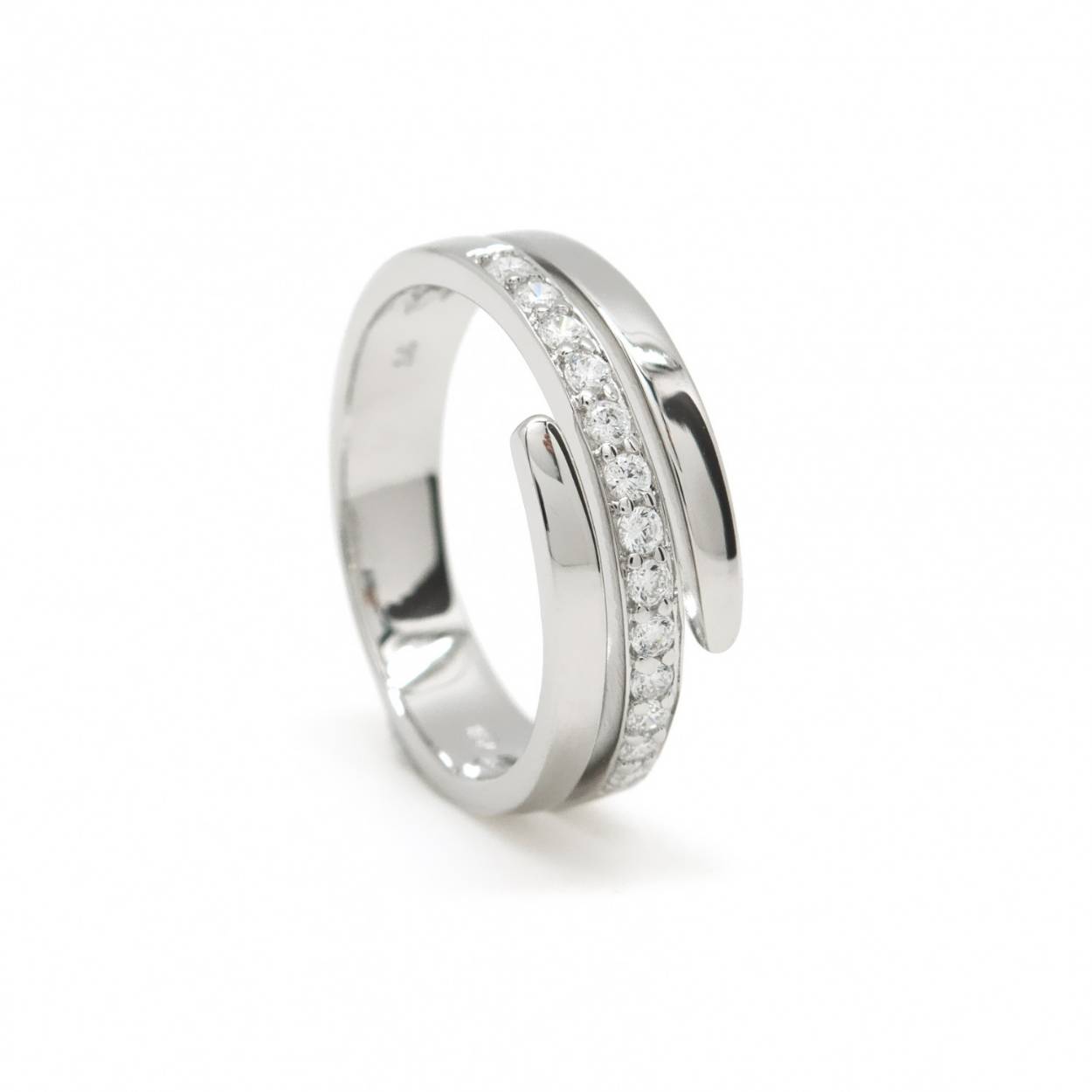 Silver zircon ring formed by a spiral made of smooth silver and a central lane of set zircons.